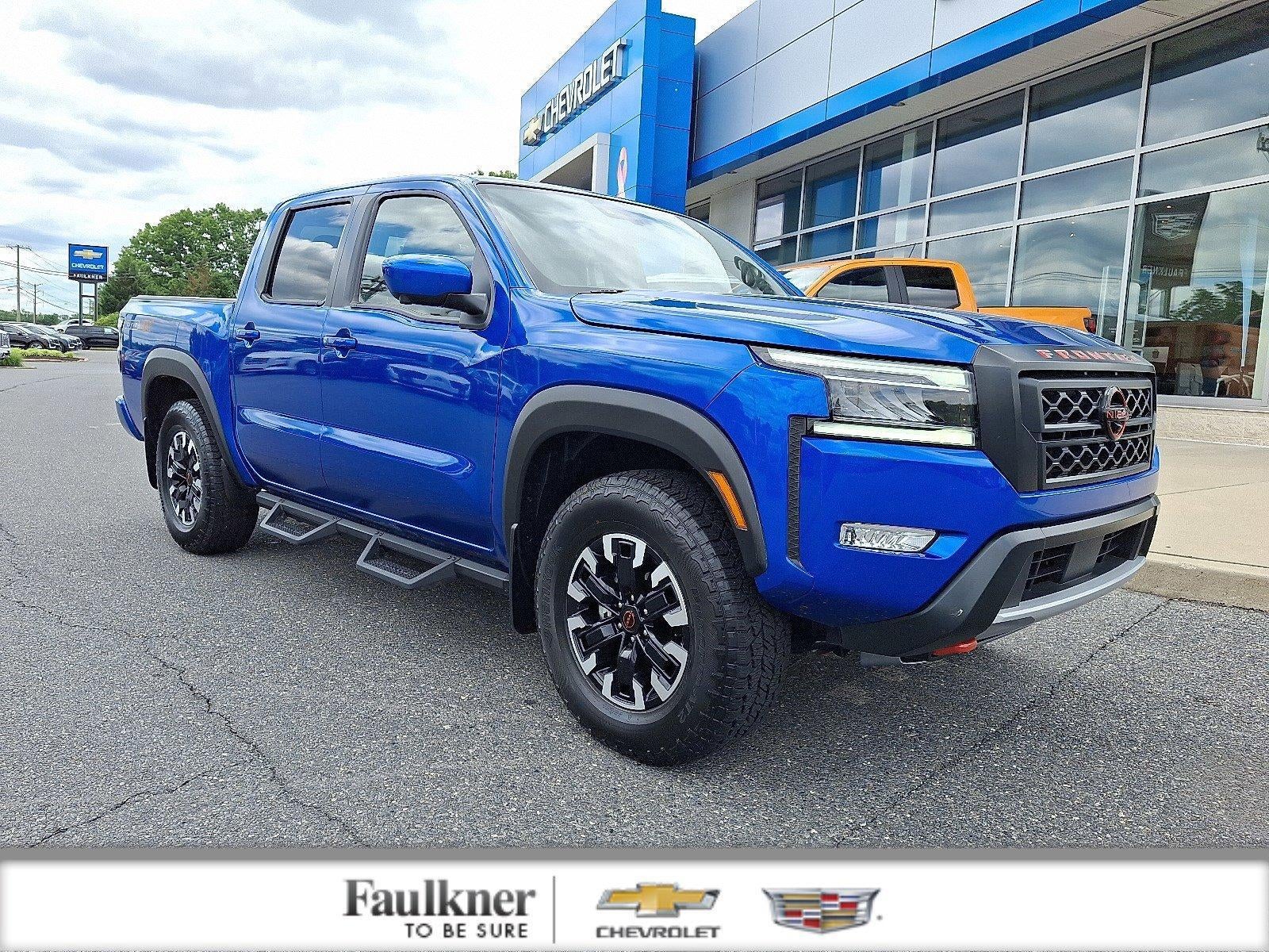 2024 Nissan Frontier Crew Cab PRO-4X 4x4 in Bluestone Pearl — front three-quarter view